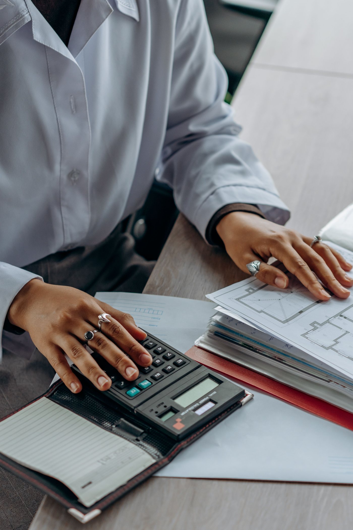 Mesa de trabalho com documentos, calculadora e análise contábil
